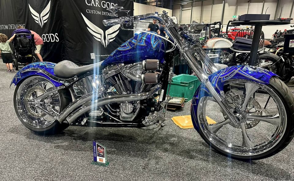 Blue custom Softail on display at a bike show